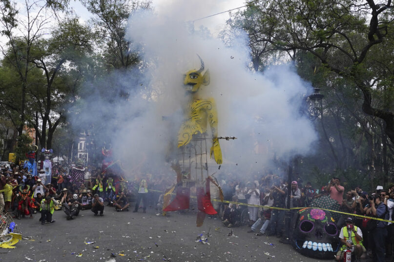 Residents gather to watch the burning of a cardboard figure representing Judas at the Santa María La Ribera Cultural Center, in Mexico City, Saturday, April 8, 2023. Every Holy Saturday Mexicans prepare for the traditional 