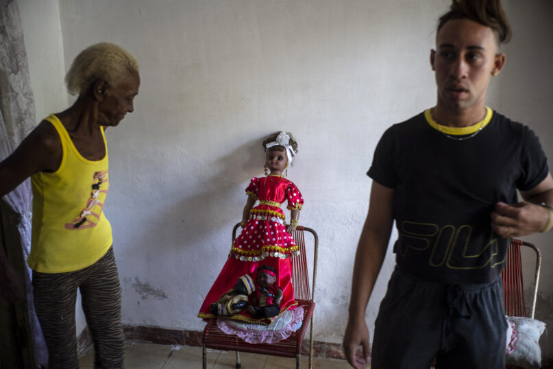 A doll depicting the Yoruba deity Yemayá is propped up on a chair before the start of a Santería ceremony in the home of Mandy Arrazcaeta, in Havana, Cuba, Sunday, Nov. 13, 2022. A fusion of African religions and Catholicism, Santería was one of the few religious practices to endure through decades of prohibitions by the communist government. (AP Photo/Ramon Espinosa)