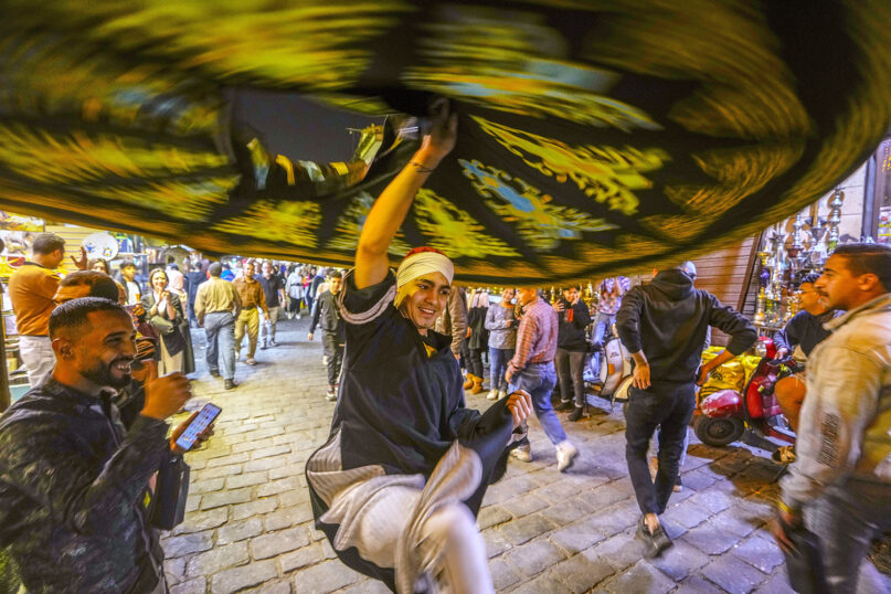 A whirling dervish spins during a traditional performance during the holy month of Ramadan at Al Muezz Street in Cairo, Egypt, late Tuesday, April 4, 2023.  (AP Photo/Amr Nabil)