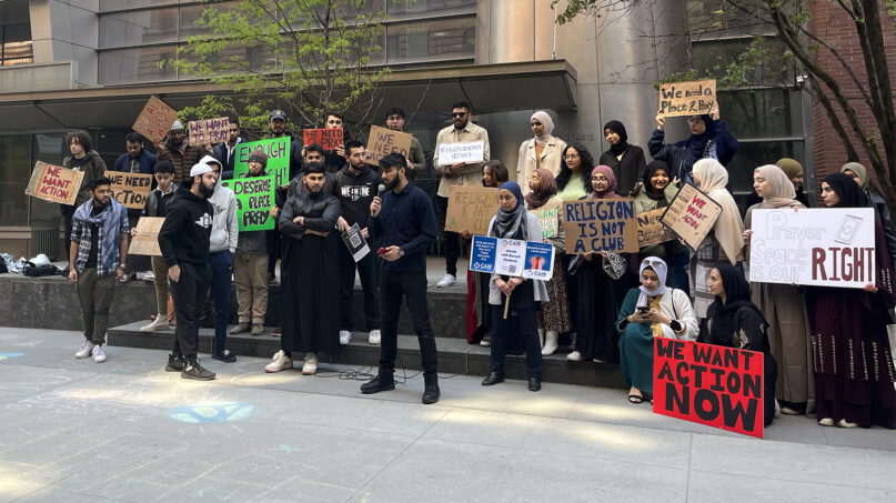 Furqan Khan, center with microphone, speaks as students and supporters demonstrate for better religious spaces at Baruch College, Thursday, April 20, 2023, in New York City. Photo by Heerea Kaur Rikhraj