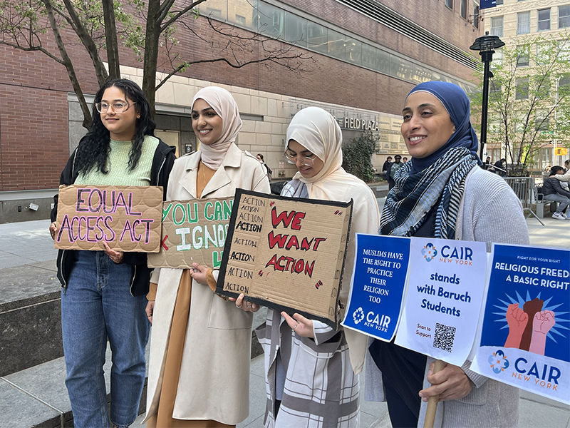 People pose with signs while demonstrating at Baruch College, Thursday, April 20, 2023, in New York City. Photo by Heerea Kaur Rikhraj