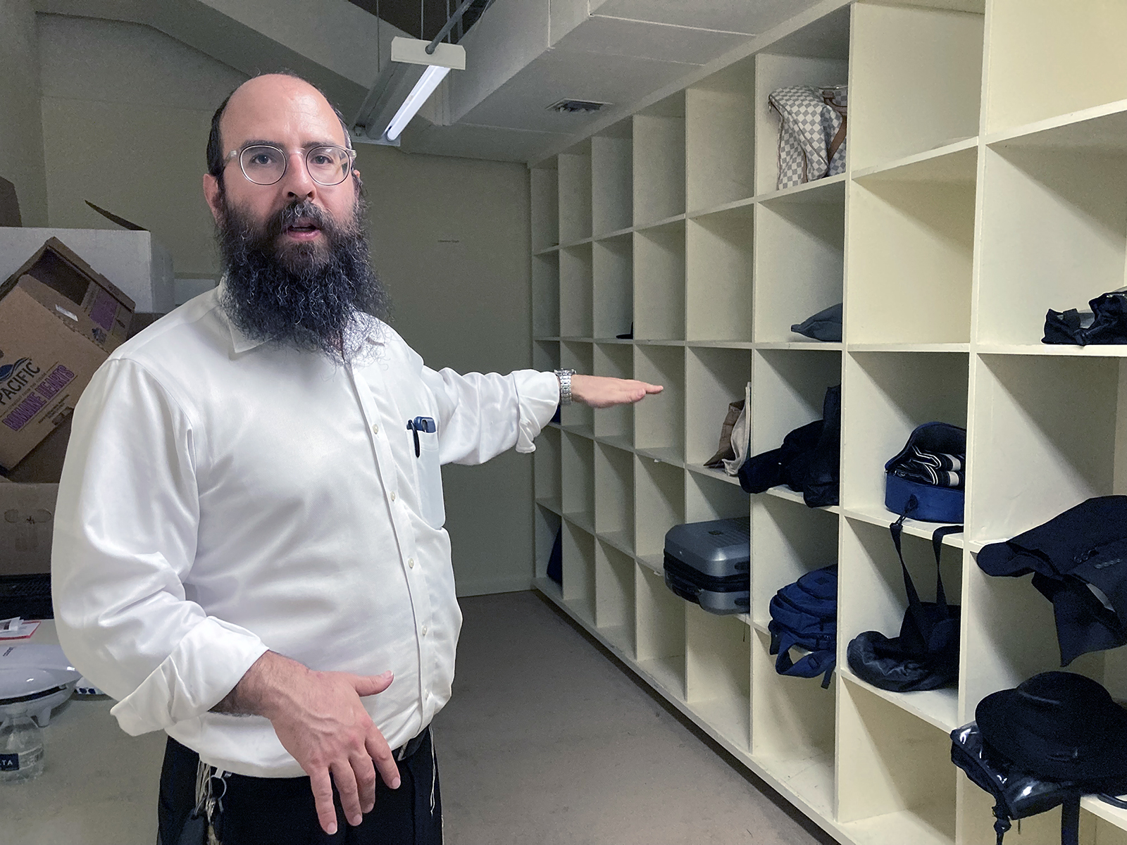 Chabad Rabbi Yosef Plotkin shows the cubbies where Jews attending the High Point Furniture Market can leave their bags during the day. RNS photo by Yonat Shimron