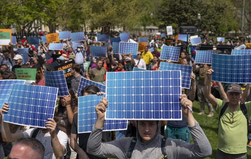 FILE - Activists display prints replicating solar panels during a rally to mark Earth Day at Lafayette Square, Washington, April 23, 2022. (AP Photo/Gemunu Amarasinghe, File)