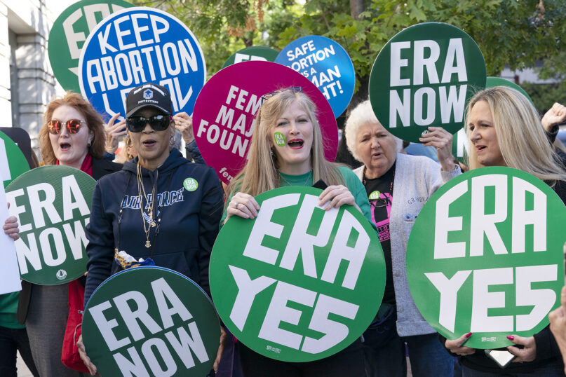 Demonstrators protest outside of the federal courthouse, asking Congress to pass the Equal Rights Amendment, during a rally in Washington, Sept. 28, 2022. (AP Photo/Jose Luis Magana)