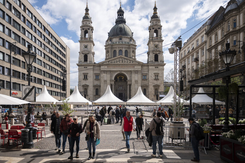 Tourists walk in front of St. Stephen’s Basilica in Budapest on April 27, 2023, where Pope Francis will meet with bishops, priests and pastoral workers during his visit to Hungary. The spiritual priorities of Pope Francis will be on display during a trip this week to Hungary, where the populist government will seek to downplay its diverging views on matters such as immigration and minority rights while focusing instead on points where it aligns with the pontiff. (AP Photo/Denes Erdos)