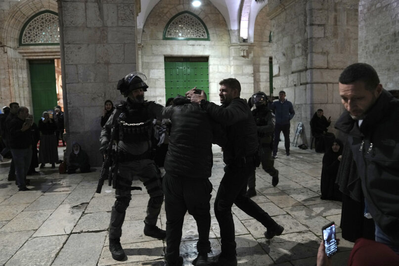 Israeli police arrest a Palestinian worshipper at the Al-Aqsa Mosque compound in the Old City of Jerusalem during the Muslim holy month of Ramadan, April 4, 2023. Palestinian media reported police attacked Palestinian worshippers, raising fears of wider tension as Islamic and Jewish holidays overlap. (AP Photo/Mahmoud Illean)