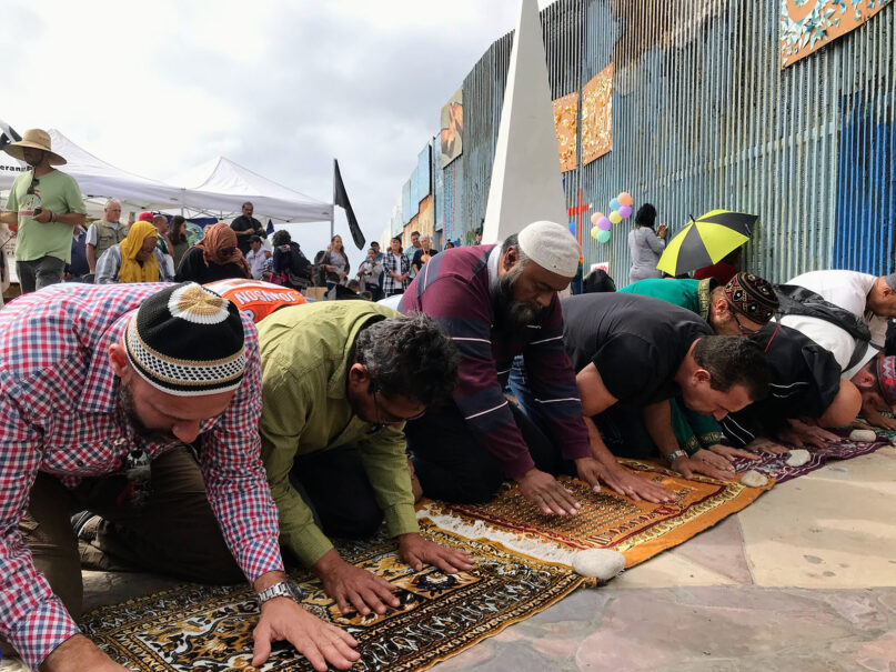 Muslims gather in midday prayer on Sunday, Oct. 27, 2019, along the U.S.-Mexico border in Tijuana. RNS photo by Alejandra Molina