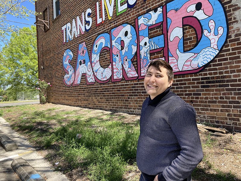 Noah Rubin-Blose is a fellow at Svara, a queer yeshiva, and is also studying to be a rabbi at the Reconstructionist Rabbinical College. He lives in Durham, North Carolina, where he poses by a "Trans Lives Are Sacred" mural. RNS photo by Yonat Shimron