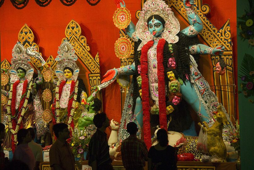 People admire a massive statue of the Hindu goddess Kali. (Jerry Redfern/LightRocket via Getty Images)