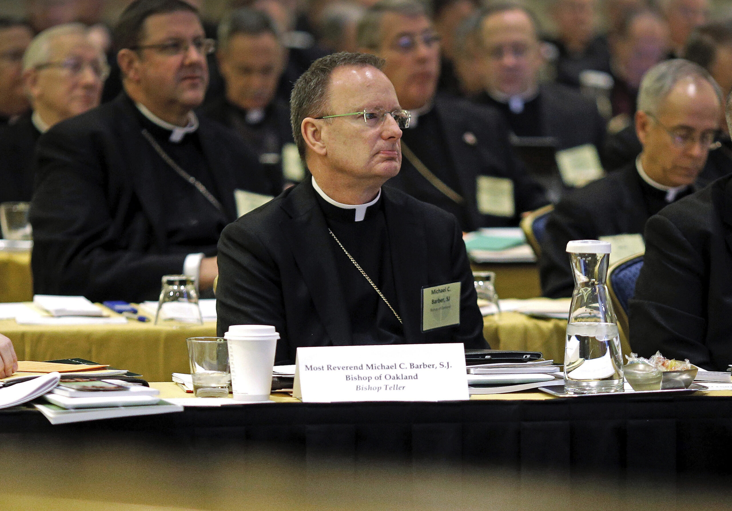 FILE - Roman Catholic Diocese of Oakland Bishop Michael Barber, center, listens to a presentation alongside fellow bishops at the United States Conference of Catholic Bishops' annual fall meeting in Baltimore, Nov. 12, 2013. On Monday, May 8, 2023, the Roman Catholic Diocese of Oakland filed for bankruptcy due to hundreds of new child sex abuse claims, becoming the second diocese in California to do so. The San Francisco Bay Area diocese faces more than 330 lawsuits brought under a California law allowing claims that would have otherwise expired, Barber said in a letter posted to the diocese's website. (AP Photo/Patrick Semansky, File)