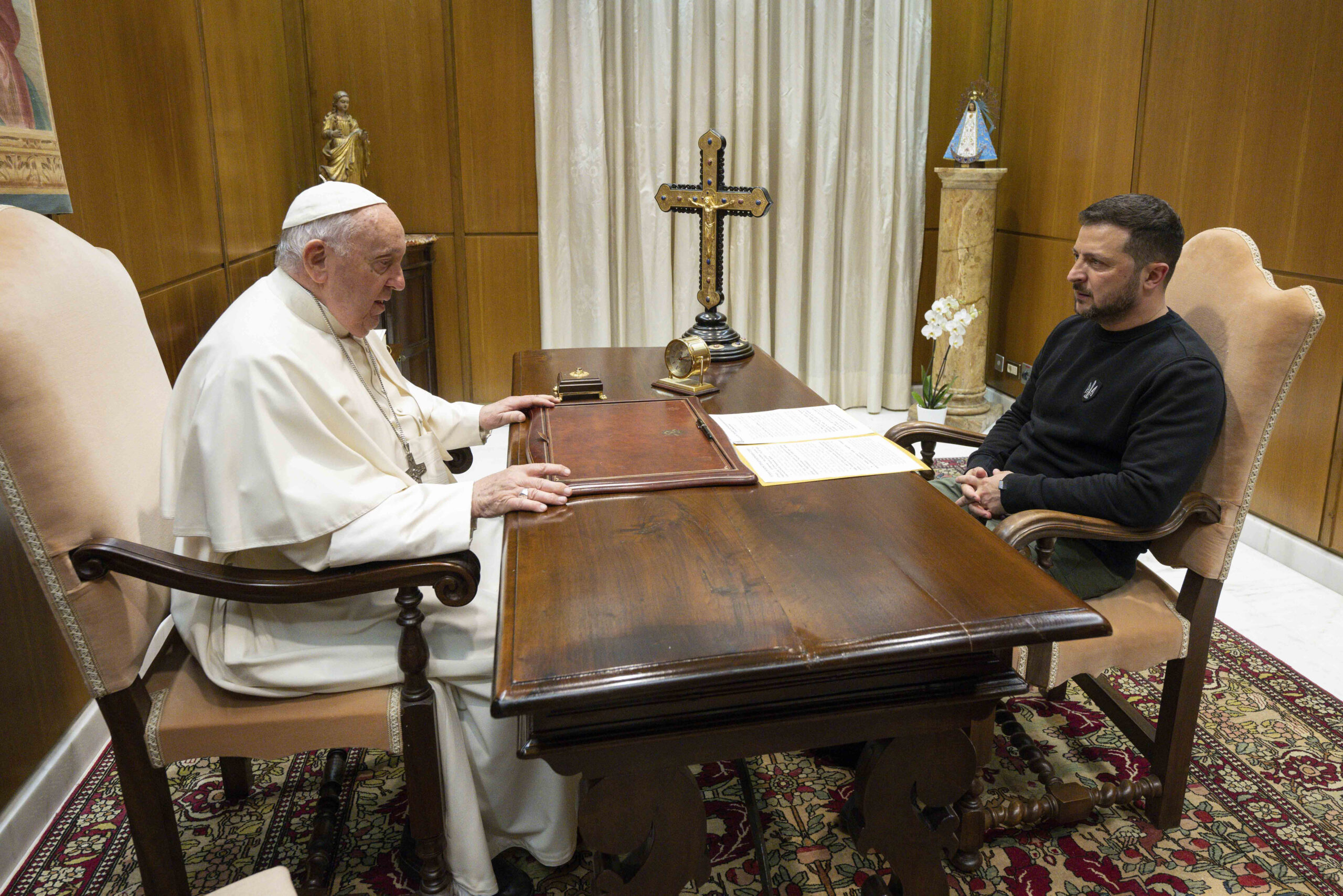 This image made available by Vatican News shows Pope Francis meeting Ukrainian President Volodymyr Zelenskyy during a private audience at The Vatican, Saturday, May 13, 2023. Francis recently said that the Vatican has launched a behind-the-scenes initiative to try to end the war launched last year by Russia. (Vatican News via AP)