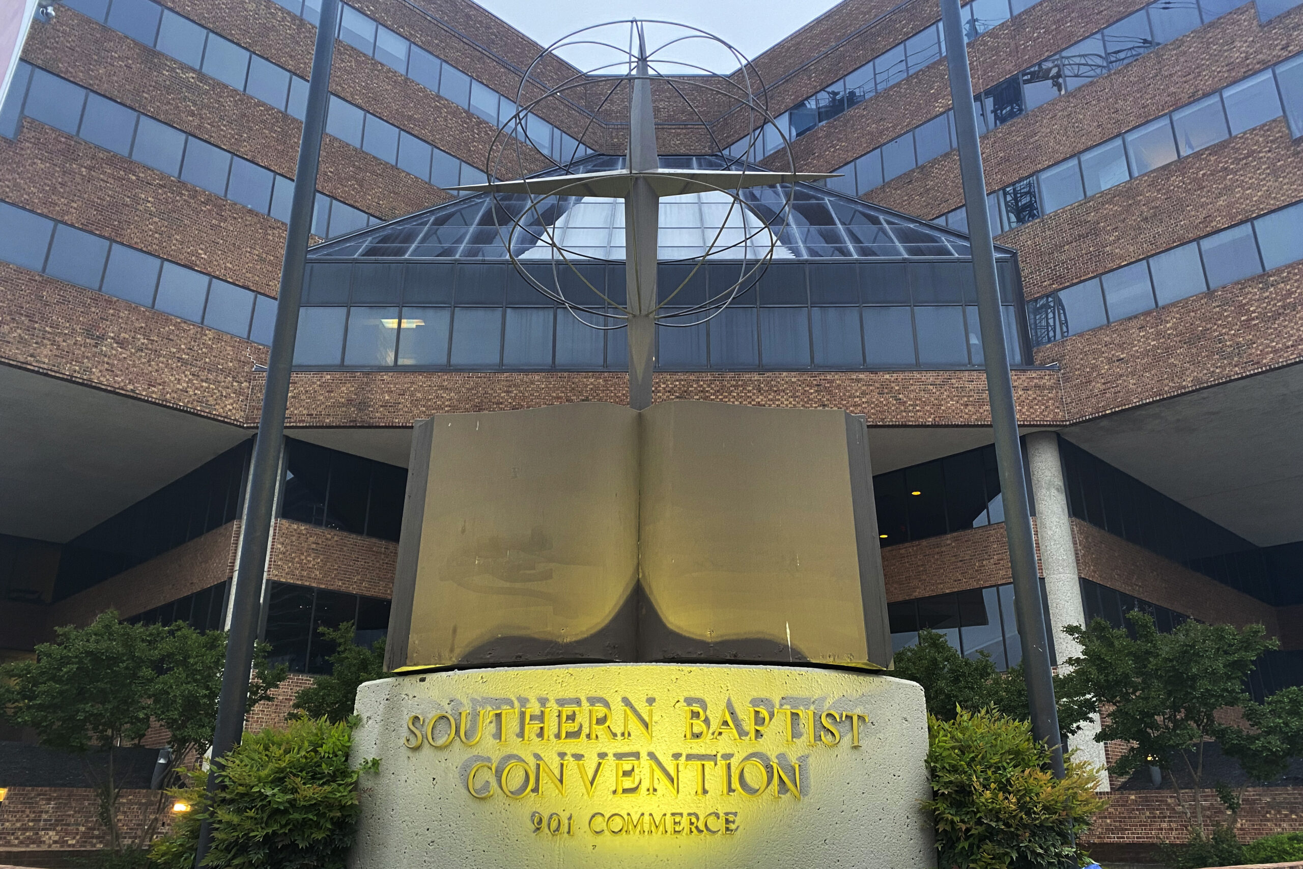 FILE - A cross and Bible sculpture stand outside the Southern Baptist Convention headquarters in Nashville, Tenn., May 24, 2022. A powerful Southern Baptist committee was looking to appoint a new leader Monday, May 1, 2023, who could navigate controversies over its handling of sexual-abuse reforms and the ousting of churches with women serving as pastors. Instead, the Executive Committee found itself tangled in yet another dispute, voting down a recommendation to make its own former chairman its president in what had become a racially fraught decision. (AP Photo/Holly Meyer, File)