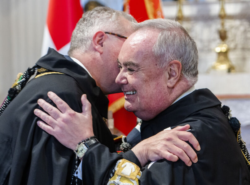 John Dunlap, right, is congratulated by the Grand Commander of the Sovereign Military Order of Malta, Emmanuel Rousseau after swearing in as 81st grand master of the order in Rome, Wednesday, May 3, 2023. (AP Photo/Domenico Stinellis)