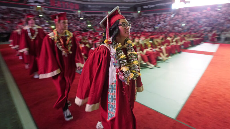 FILE - Amryn Tom graduates from Cedar City High School on Wednesday, May 25, 2022, in Cedar City, Utah. Tom is wearing an eagle feather given to her by her mother and a cap that a family friend beaded. (AP Photo/Rick Bowmer, File)