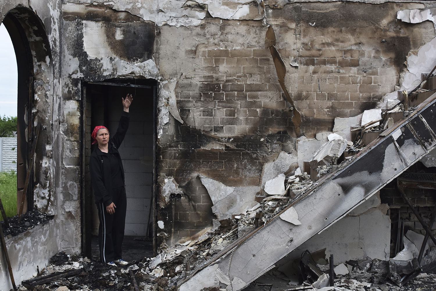 Valentina, 53, a local woman, stands inside of Evangelical Christian Baptists prayer house which was destroyed yesterday by a Russian attack in Orihiv, Ukraine, on Monday, May 22, 2023. (AP Photo/Andriy Andriyenko)
