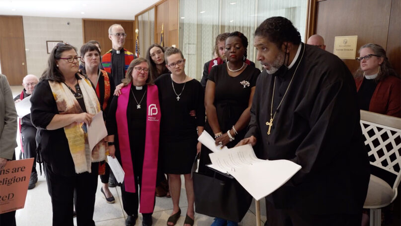 The Rev. William J. Barber II, right, leads a press conference about opposition to an abortion bill in the hallway of the North Carolina General Assembly, Friday, May 12, 2023, in Raleigh, North Carolina. Video screen grab