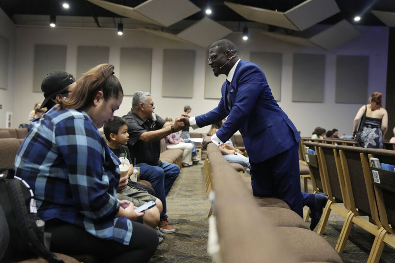 Pastor Les Robinson interacts with members of the congregation at The Sanctuary Church Sunday, May 14, 2023, in Santa Clarita, Calif. For Black Californians who have watched for nearly two years as the state has come further than any other in its consideration of reparations for African Americans, the approval of restitution proposals by a historic task force marks a moment some never thought would come and one others say is a long time coming. (AP Photo/Marcio Jose Sanchez)