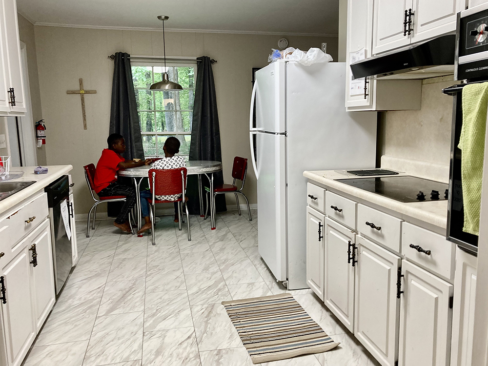 Two boys, part of a refugee family from the Democratic Republic of Congo, share an afternoon snack at a house owned by Temple Baptist Church in Durham, North Carolina. RNS photo by Yonat Shimron