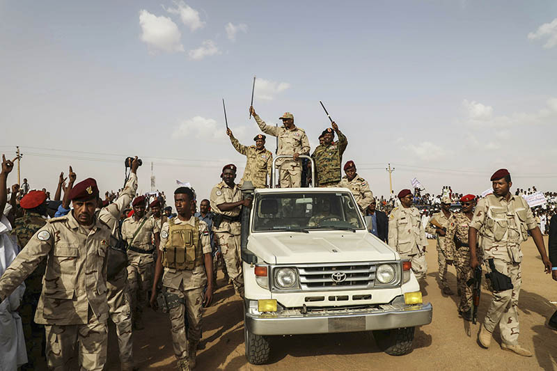 File - Gen. Mohammed Hamdan Dagalo waves to a crowd during a military-backed tribe's rally, in the Nile River state, Sudan, Saturday, July 13, 2019. (AP Photo/Mahmoud Hjaj, File)