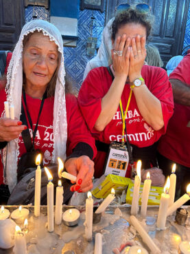 Pilgrims light candles at El Ghriba synagogue on the Tunisian island of Djerba in May 2023. Photo by David Benaym