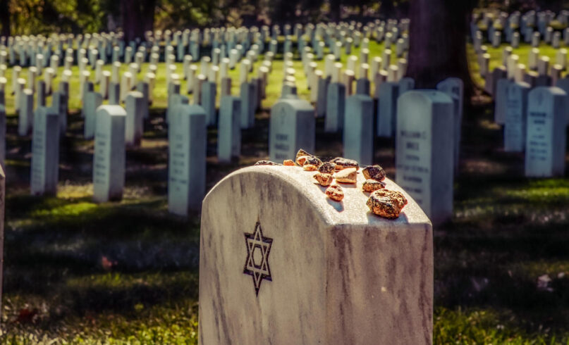 Some Jews believe putting stones on a grave keeps the soul in this world, which some find comforting. Others believe the stones keep demons from getting into the graves. A stone does not die like flowers and can symbolize the permanence of memory and legacy. Taken at a national cemetery in Virginia. (Bill Chizek Photography / Alamy Stock Photo)