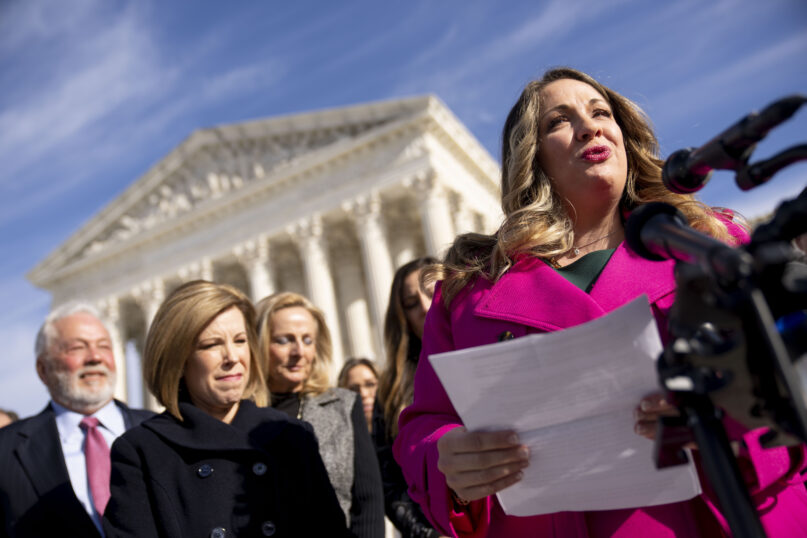 FILE - Lorie Smith, a Christian graphic artist and website designer in Colorado, right, accompanied by her lawyer, Kristen Waggoner of the Alliance Defending Freedom, second from left, speaks outside the Supreme Court in Washington, Monday, Dec. 5, 2022, after her case was heard before the Supreme Court. In a defeat for gay rights, the Supreme Court's conservative majority ruled Friday, June 30, 2023, Smith who wants to design wedding websites can refuse to work with same-sex couples. (AP Photo/Andrew Harnik, File)