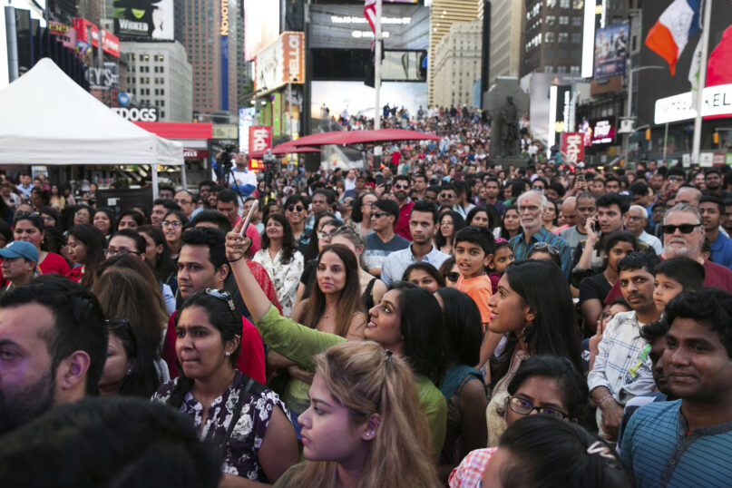 FILE — Spectators look on during the Diwali festival at a Times Square celebration, Oct. 7, 2017, in New York. New York City will add the Hindu festival of Diwali to the list of public school holidays in recognition of the growth of the city's South Asian and Indo-Caribbean communities, Mayor Eric Adams announced Monday, June 26, 2023. (AP Photo/Kevin Hagen)