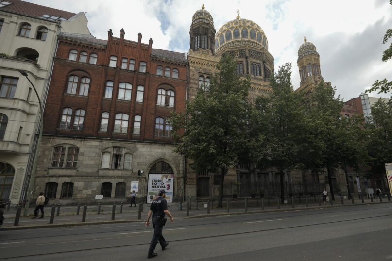 A police officer patrols in front of the 'New Synagogue' in central Berlin, Germany, Tuesday, June 27, 2023. The annual antisemitism report with figures from 2022 of the Department for Research and Information on Anti-Semitism, or RIAS, is presented in the German capital Berlin. (AP Photo/Markus Schreiber)