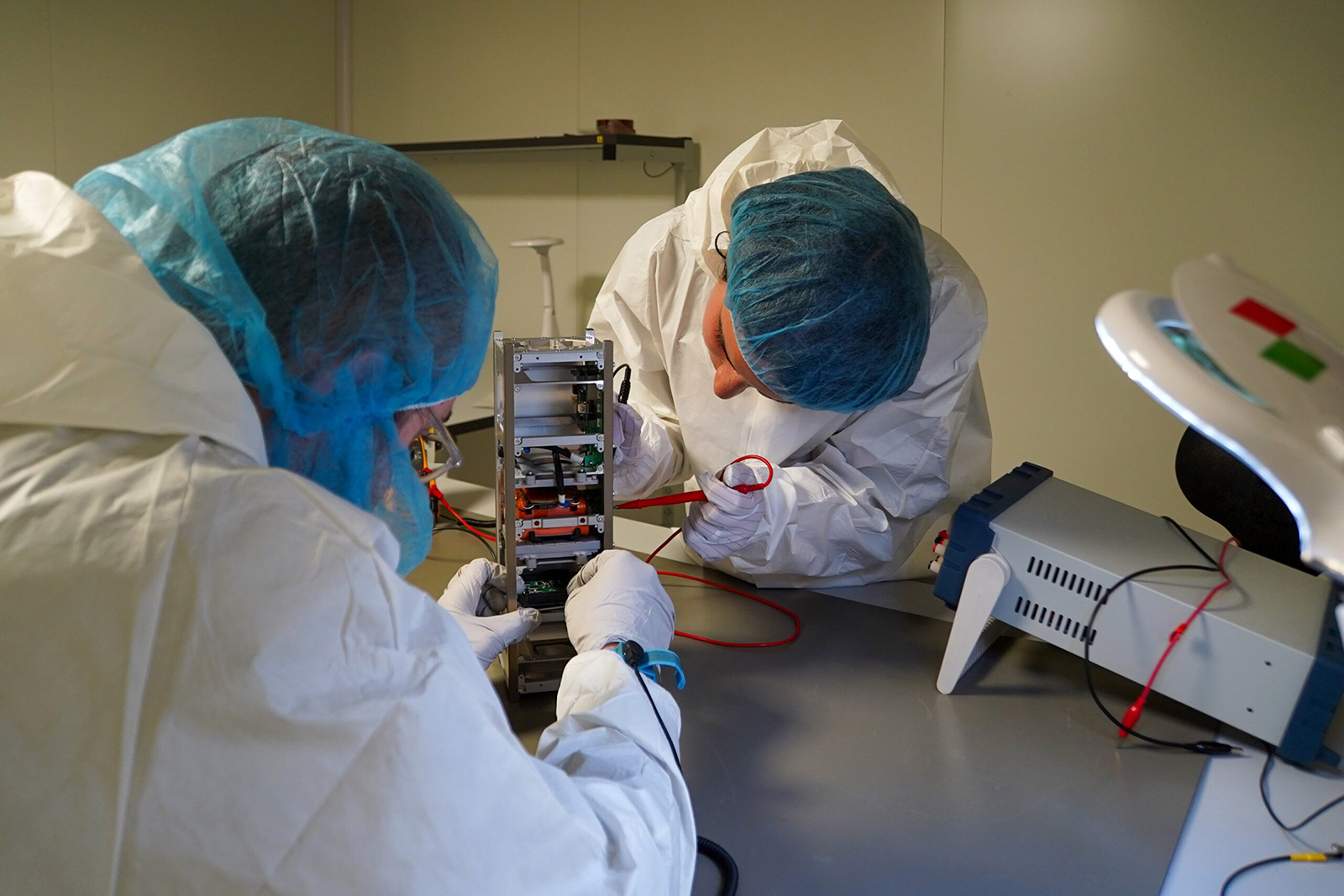 In this undated photo, students at the Polytechnic University of Turin work on "Spei Satelles," a small CubeSat satellite they built. The satellite carries a "nano" version of Pope Francis' book, "Why Are You Afraid? Have You No Faith?" It is also built to send signals back to earth for ham radio operators to hear the pope's messages of hope and peace. (Photo courtesy Vatican Media)