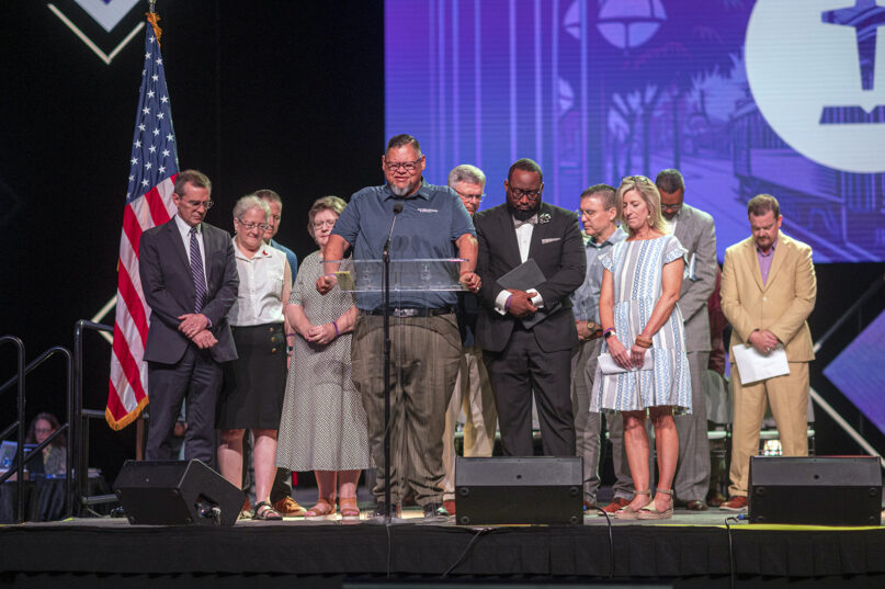 Pastor Mike Keahbone, center, leads prayer with the Southern Baptist Convention’s Abuse Reform Implementation Task Force during the SBC annual meeting at the Ernest N. Morial Convention Center in New Orleans, June 14, 2023. RNS photo by Emily Kask