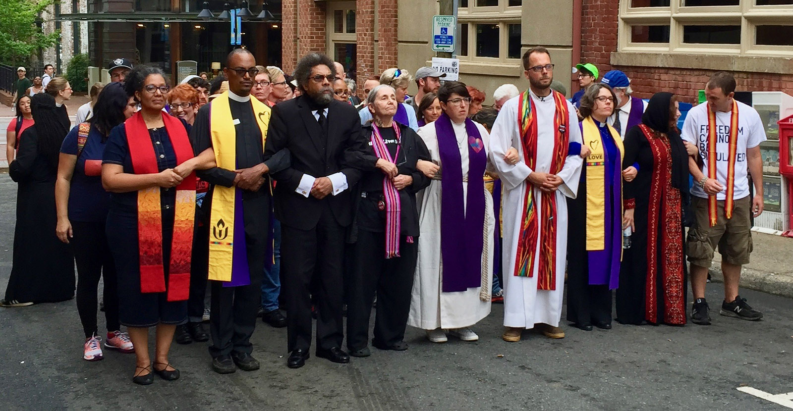 The Rev. Susan Frederick-Gray, third from right with yellow stoll, marches with other clergy in Charlottesville in 2017. Photo © 2017 Nora Rasman/UUA