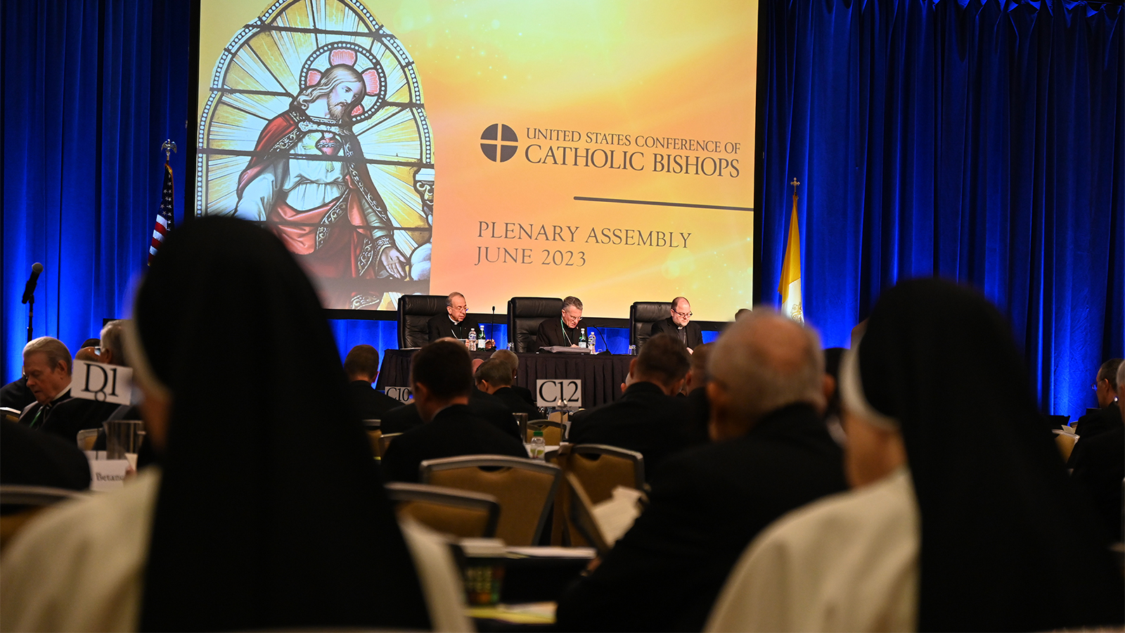 Two nuns, foreground, attend the U.S. Conference of Catholic Bishops meeting in Orlando, Florida, Thursday, June 15, 2023. RNS photo by Jack Jenkins