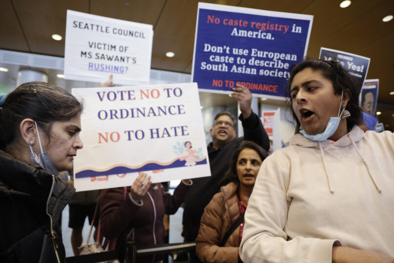 Supporters and opponents of a proposed ordinance to add caste to Seattle's anti-discrimination laws attempt to out voice each other during a rally at Seattle City Hall, Tuesday, Feb. 21, 2023, in Seattle. (AP Photo/John Froschauer)
