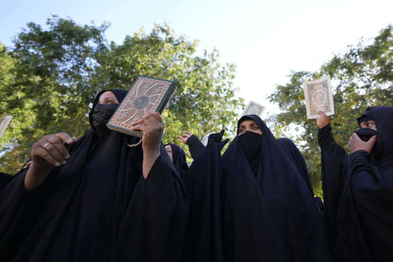 Iraqis raise copies of the Quran, Muslims' holy book, during a protest in Baghdad, Iraq, Saturday, July 22, 2023. Hundreds of protesters attempted to storm Baghdad’s heavily fortified Green Zone, which houses foreign embassies and the seat of Iraq’s government, following reports of the burning of a Quran by a ultranationalist group in front of the Iraqi Embassy in Copenhagen. (AP Photo/Hadi Mizban)