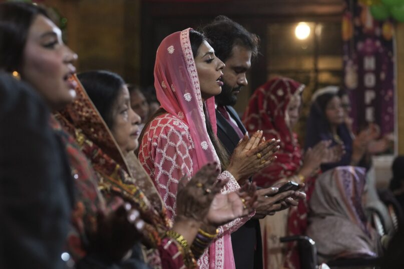 Pakistani Christians praying at a church. (AP Photo/Fareed Khan)