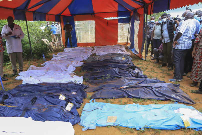 FILE - Body bags are laid out at the scene where dozens of bodies have been found in shallow graves in the village of Shakahola, near the coastal city of Malindi, in southern Kenya on April 24, 2023. The number of people who died in connection with Kenya’s doomsday cult crossed the 400 mark as detectives exhumed 12 more bodies on July 18, 2023, believed to be followers of a pastor who ordered them to fast to death in order to meet Jesus. Pastor Paul Mackenzie, who is linked to the cult based in a forested area in Malindi, coastal Kenya, is in police custody, along with 36 other suspects. All have yet to be charged. (AP Photo)