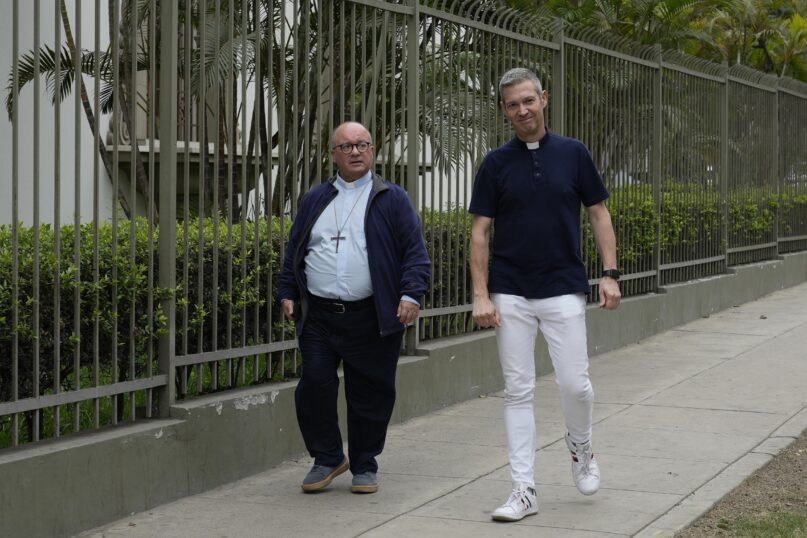 Vatican investigators, Archbishop Charles Scicluna, from Malta, left, and Monsignor Jordi Bertomeu, from Spain, walk outside of the Nunciatura Apostolica during a break from meeting with people who allege abuse by the Catholic lay group Sodalitium Christianae Vitae (SCV) in Lima, Peru, Tuesday, July 25, 2023. The investigators began an audit of the SCV with interrogations of its representatives, alleged victims and journalists who have investigated charges against the brotherhood of alleged sexual abuse and financial corruption. (AP Photo/Martin Mejia)