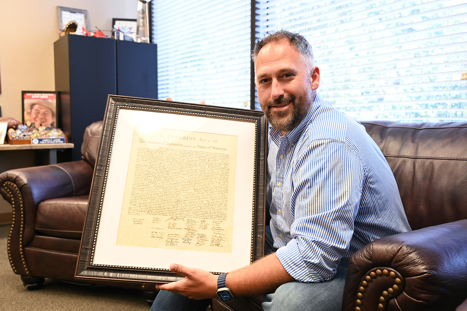 Citizens Defending Freedom spokesman James Judge holds a copy of the Declaration of Independence in his Tampa, Fla., office. RNS photo by Jack Jenkins.