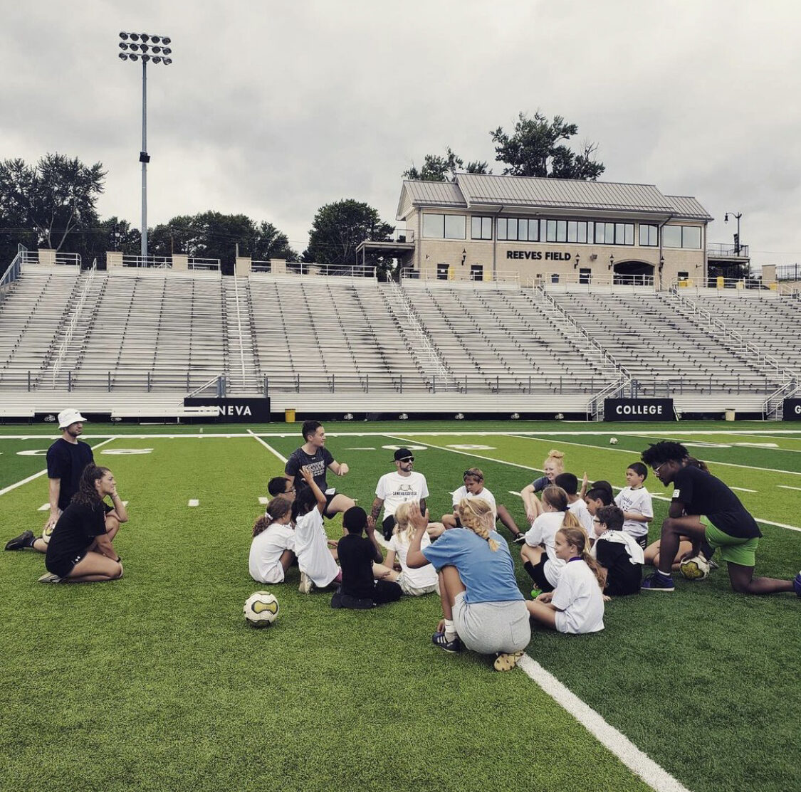 Former Geneva College soccer coach Kelsey Morrison works with a group of youth soccer players at Reeves Field. Photo courtesy of Morrison