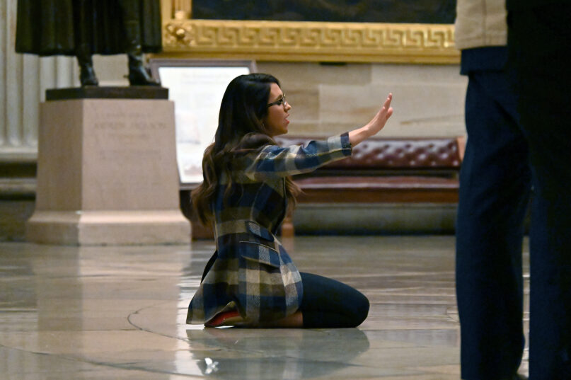 Rep. Lauren Boebert, R-Colo., kneels during a worship service led by musician Sean Feucht in the rotunda of the U.S. Capitol, March 9, 2023, in Washington. RNS photo by Jack Jenkins