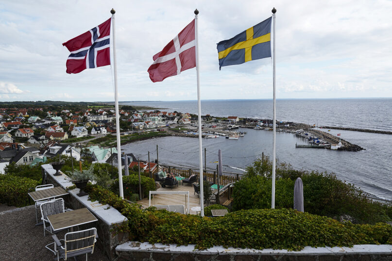 Flags of Norway, Denmark and Sweden, left to right, fly above the harbour of Mölle, south-west Sweden, Tuesday, July 25, 2023. (AP Photo/Pavel Golovkin)