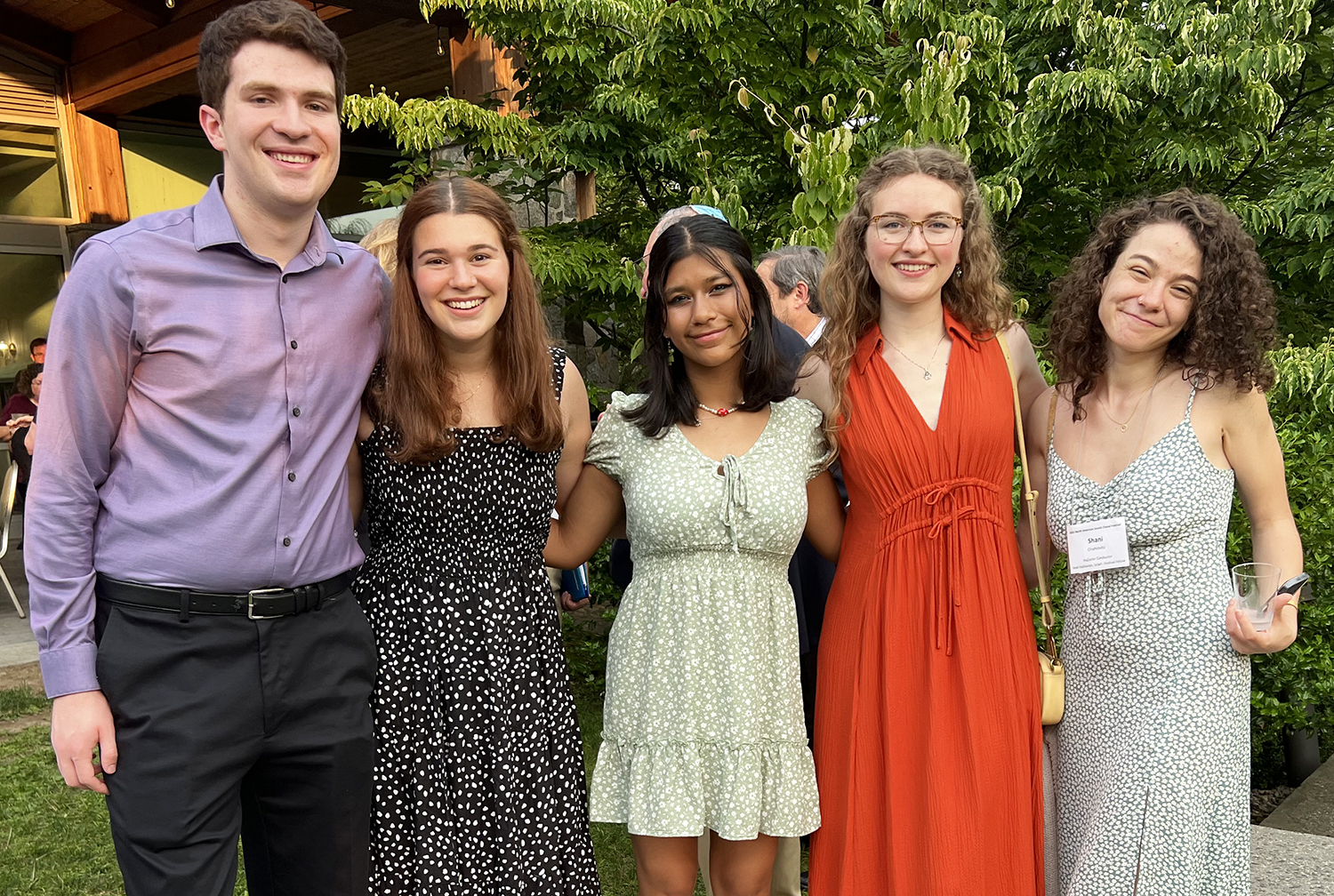 Saydie Grossman, second from the left, and Shani Chamovitz, on the right, pose with friends during an outdoor reception at the festival. RNS photo by Kathryn Post