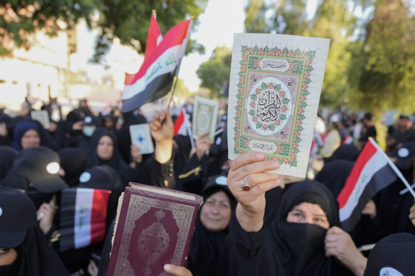 Iraqis raise copies of the Quran during a protest in Baghdad, Iraq, on July 22, 2023, following reports of the burning of the holy book in Copenhagen. (AP Photo/Hadi Mizban)