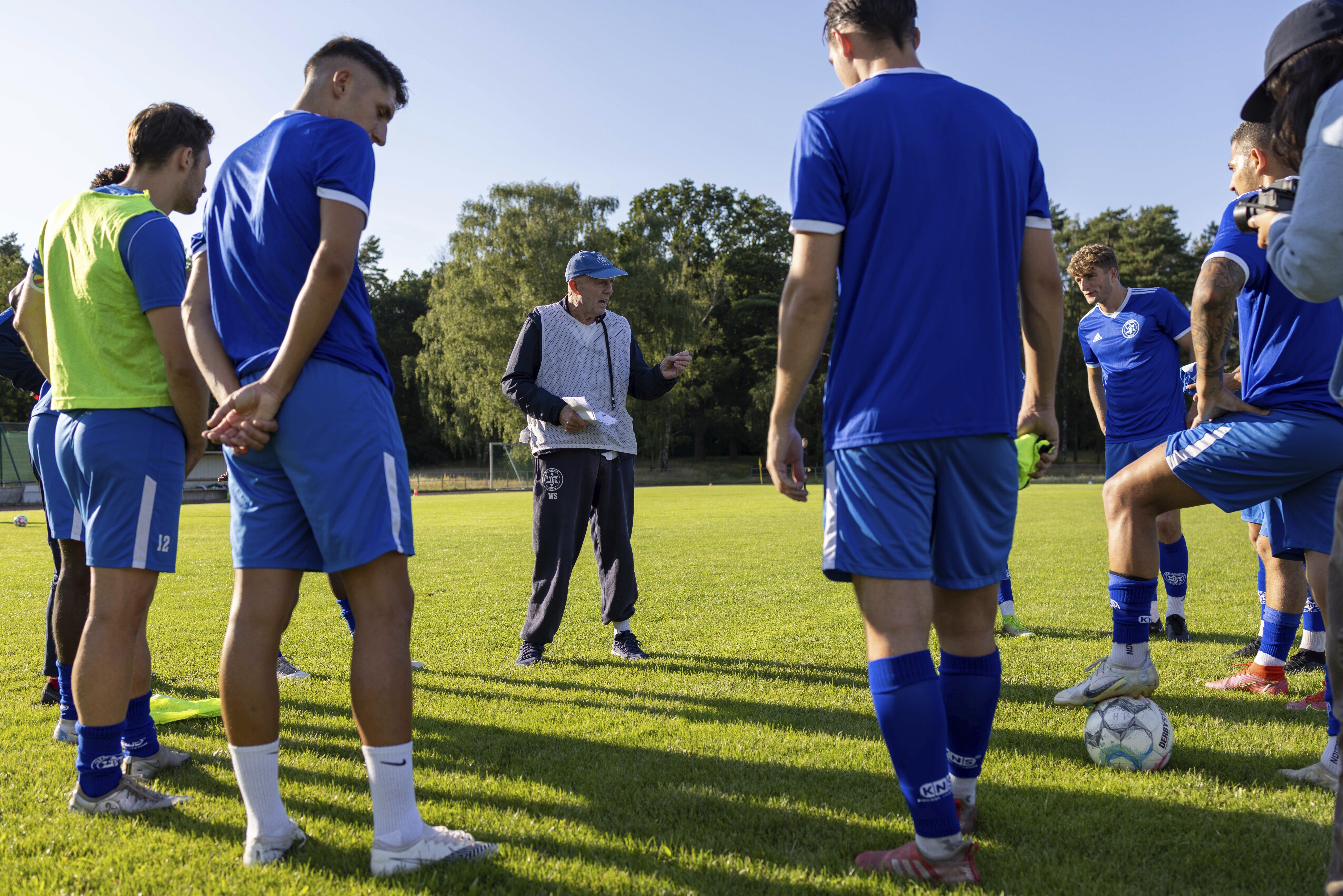 Makkabi Berlin coach Wolfgang Sandhowe instructs his players before a practice match, in Berlin, Wednesday, July 26, 2023. When Makkabi Berlin takes the field on Sunday Aug. 13, 2023, the soccer club founded by Holocaust survivors will become the first Jewish team to play in the German Cup. (AP Photo/Ciaran Fahey)