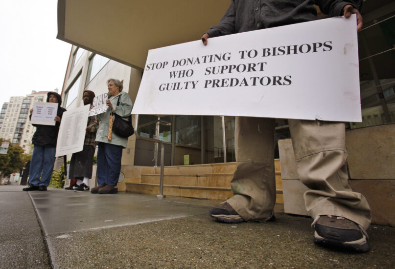 FILE - Members of SNAP (the Survivors Network of those Abused by Priests) hold up signs during a demonstration in front of the archdiocese headquarters in San Francisco, March 29, 2010. San Francisco's Roman Catholic archdiocese filed for bankruptcy Monday, Aug. 21, 2023, saying the filing is necessary to manage more than 500 lawsuits alleging child sexual abuse by church officials. (AP Photo/Paul Sakuma, File)
