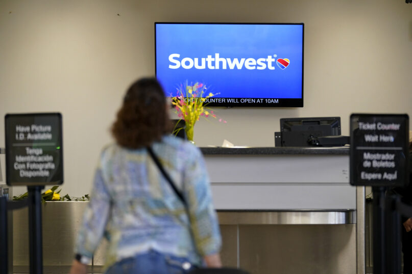 File - A Southwest Airlines passenger arrives to check-in at the Des Moines International Airport, April 18, 2023, in Des Moines, Iowa. A federal judge has set off a debate among legal scholars by ordering lawyers for Southwest Airlines to undergo 