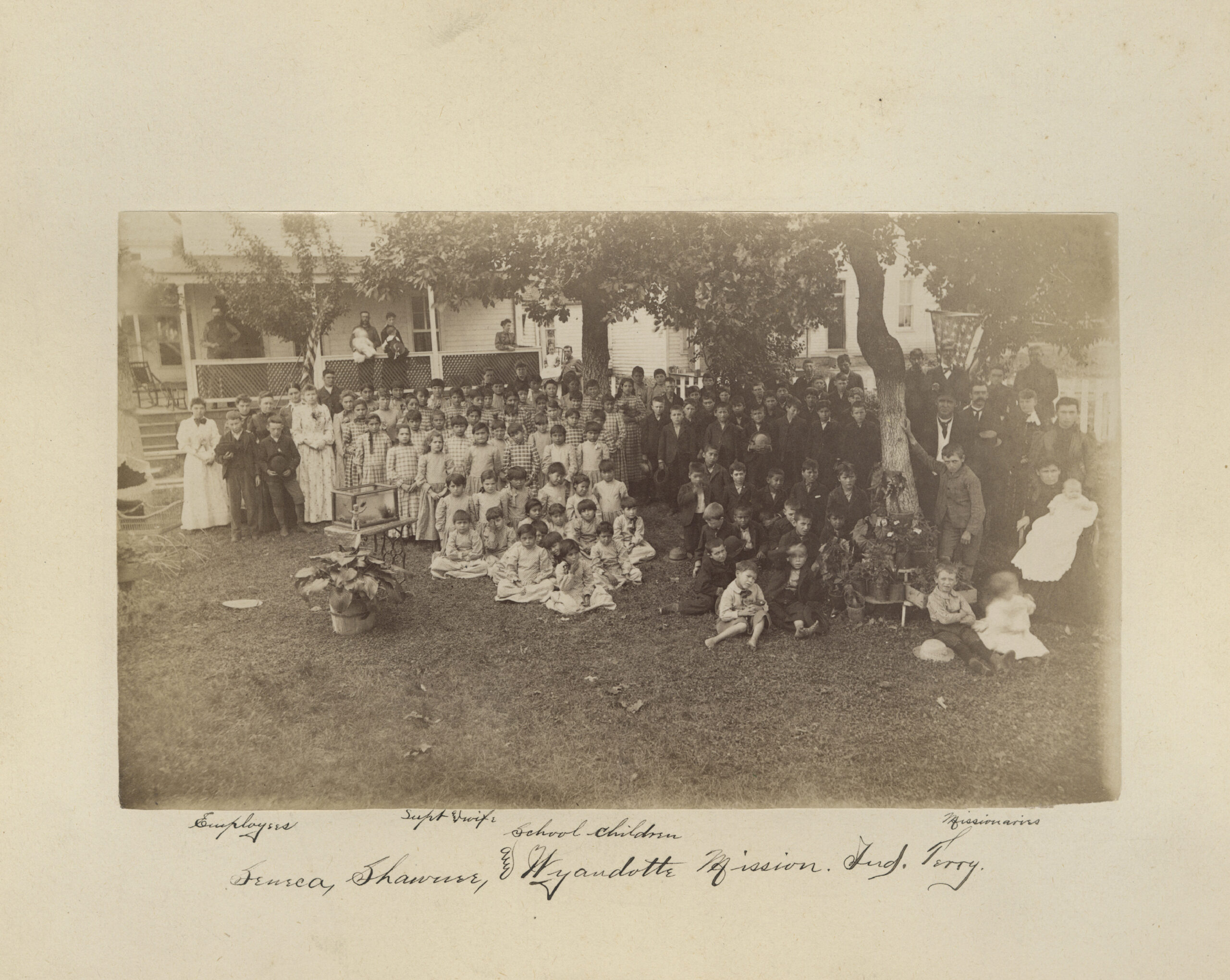 In this photo taken between 1869 and 1895, provided by the Quaker and Special Collections at Haverford College, school children of the Seneca, Shawnee, and Wyandotte Mission Indian Territory, gather for a portrait in Wyandotte, Okla. This image is one of 20,000 archival pages related to boarding schools for Native youths operated by the Quakers that will be digitized by the National Native American Boarding School Healing Coalition. (Quaker and Special Collections, Haverford College via AP)