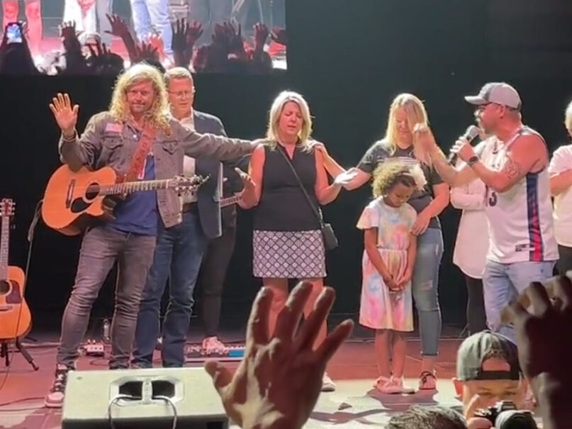 Musician Sean Feucht, from left, pastor Matt Shea and others pray over Spokane Mayor Nadine Woodward, center, during a “Let Us Worship” event in Spokane, Wash., Aug. 20, 2023. Video screen grab via Twitter/@josephdpeterson