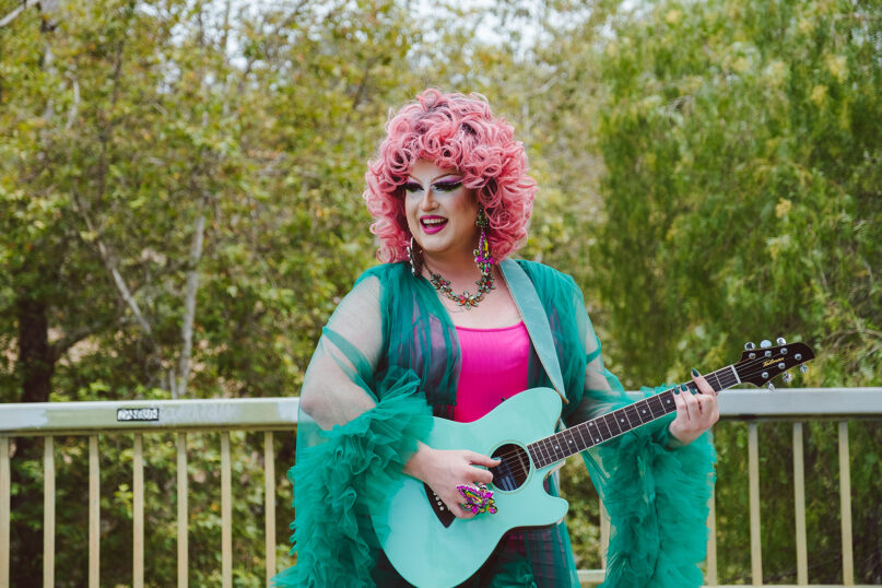 Musician and drag queen Flamy Grant plays the guitar during a photo shoot. Photo by Haley Hill