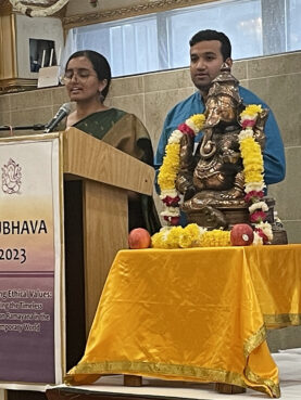 Shriya Anand, left, and Aditya Shastri address an Akshayam program at the Sri Maha Vallabha Ganapati Devasthanam in Queens, New York, Saturday, Aug. 26, 2023. RNS photo by Richa Karmarkar